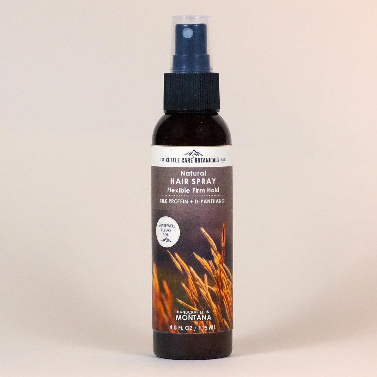 4 oz bottle of Flexible & Firm Natural Hairspray in a amber bottle set against a neutral background